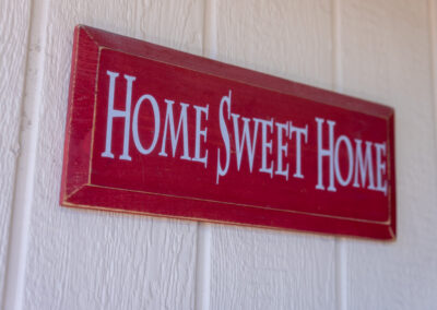 A red sign hanging on the side of a building.